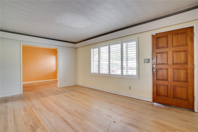 entryway with light wood-type flooring and baseboards