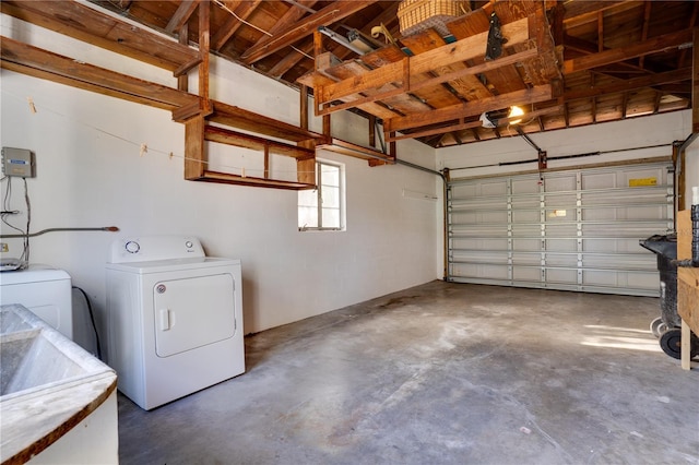 garage featuring a sink and independent washer and dryer