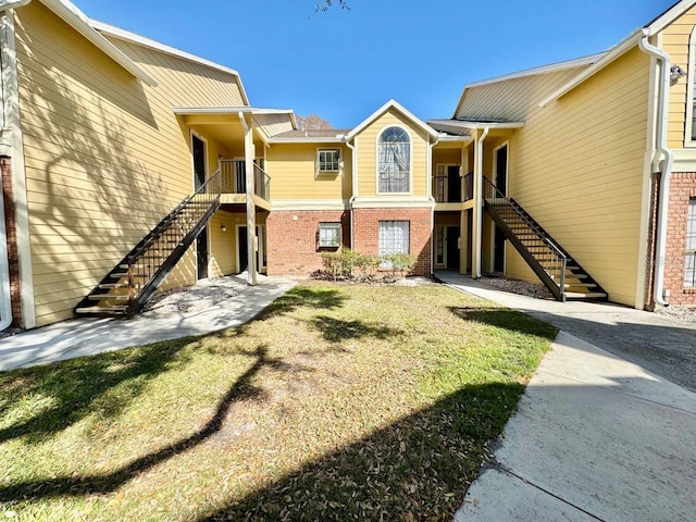 exterior space with a yard and brick siding