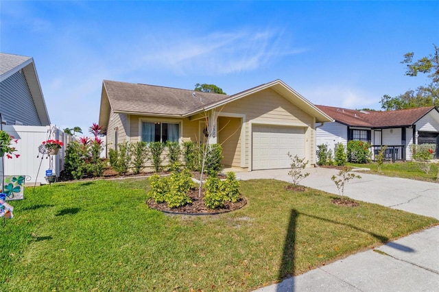 ranch-style home featuring concrete driveway, fence, a garage, and a front lawn