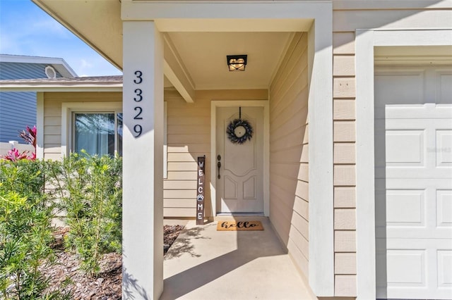 view of exterior entry featuring a garage