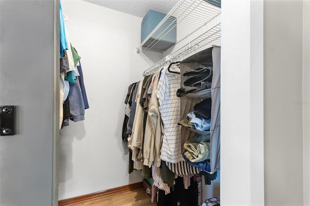 spacious closet with wood finished floors