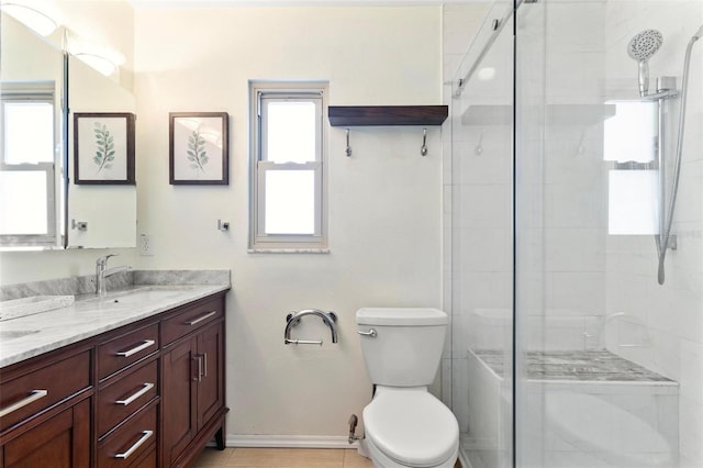 bathroom featuring double vanity, toilet, a stall shower, and a sink