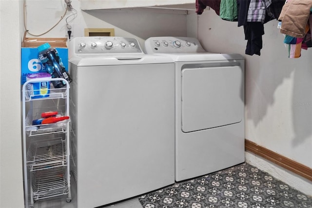 clothes washing area featuring tile patterned floors, baseboards, washing machine and dryer, and laundry area