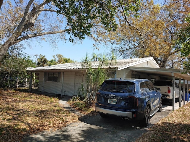 view of home's exterior featuring brick siding and a carport