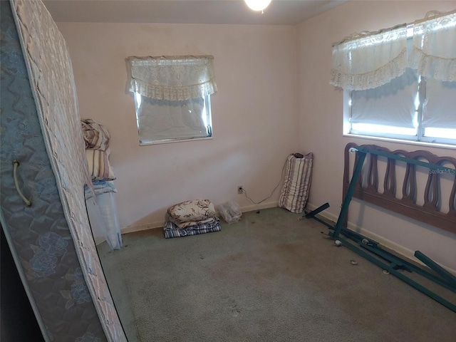 carpeted empty room with baseboards