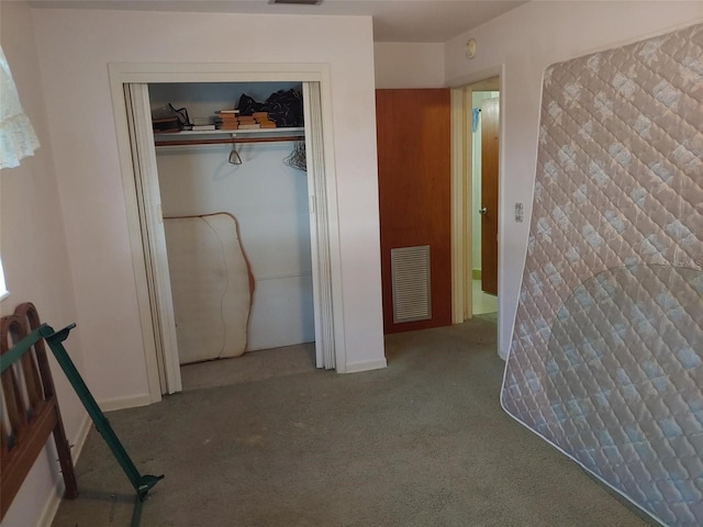 unfurnished bedroom featuring visible vents, a closet, and carpet flooring