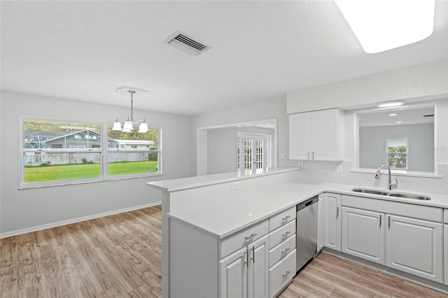 kitchen with visible vents, a sink, light countertops, dishwasher, and a healthy amount of sunlight