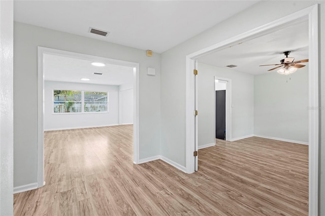 unfurnished room with visible vents, baseboards, ceiling fan, and light wood finished floors