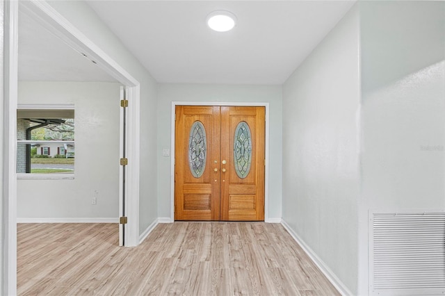 entrance foyer with visible vents, baseboards, and light wood-style floors