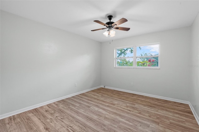 empty room featuring light wood-style flooring, baseboards, and ceiling fan