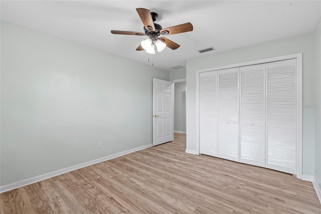 unfurnished bedroom with visible vents, baseboards, and light wood-style floors