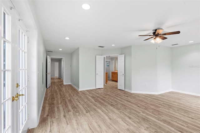 unfurnished room with visible vents, recessed lighting, light wood-type flooring, and baseboards