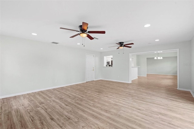 unfurnished living room featuring light wood finished floors, visible vents, baseboards, recessed lighting, and ceiling fan with notable chandelier