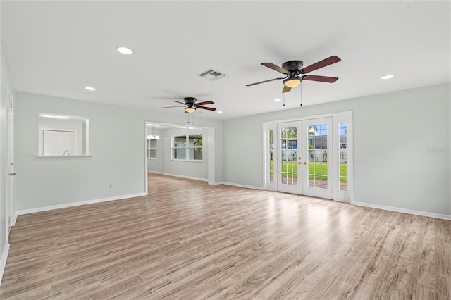 unfurnished living room featuring visible vents, baseboards, light wood-type flooring, recessed lighting, and french doors