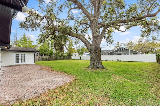 view of yard with french doors, a patio, and a fenced backyard