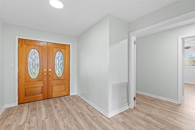 entryway with visible vents, light wood-type flooring, and baseboards