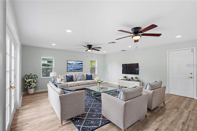 living area with visible vents, baseboards, recessed lighting, light wood-style floors, and a ceiling fan