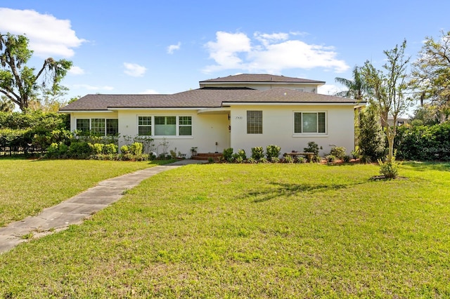 view of front of property with stucco siding and a front yard