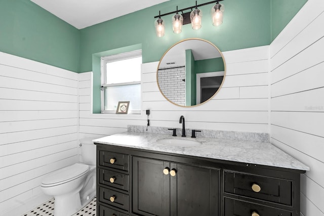 bathroom featuring toilet and vanity