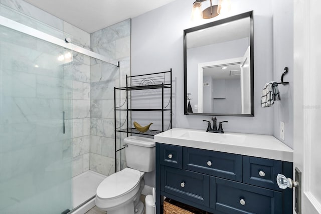 bathroom featuring a shower stall, toilet, and vanity