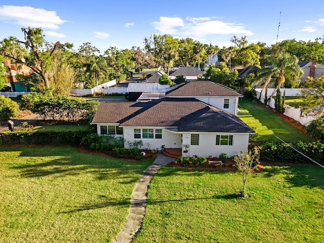 view of front of house with a front yard and fence
