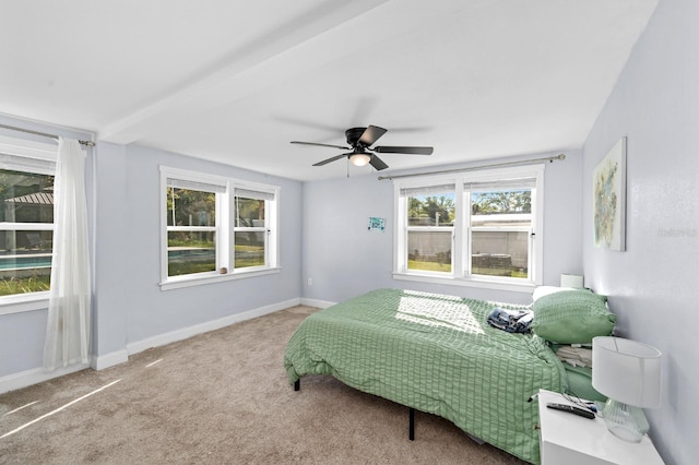 bedroom featuring baseboards, carpet floors, and a ceiling fan