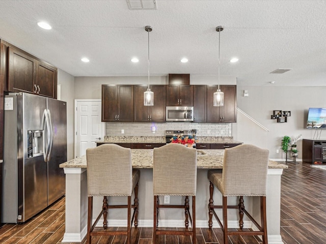 kitchen featuring visible vents, appliances with stainless steel finishes, and wood finish floors