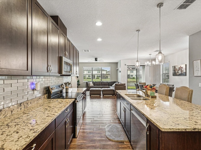 kitchen with tasteful backsplash, visible vents, dark brown cabinets, and appliances with stainless steel finishes