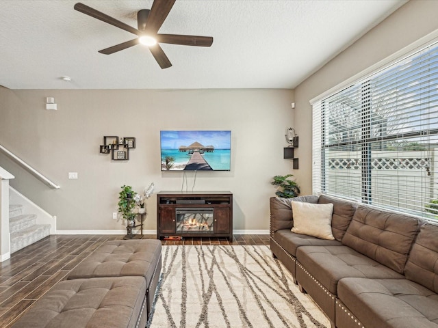 living room featuring stairs, a textured ceiling, ceiling fan, and wood tiled floor