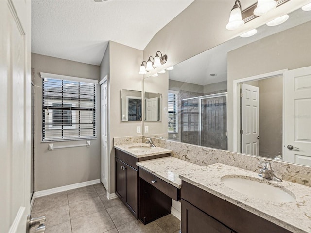 bathroom with tile patterned flooring, plenty of natural light, baseboards, and a stall shower