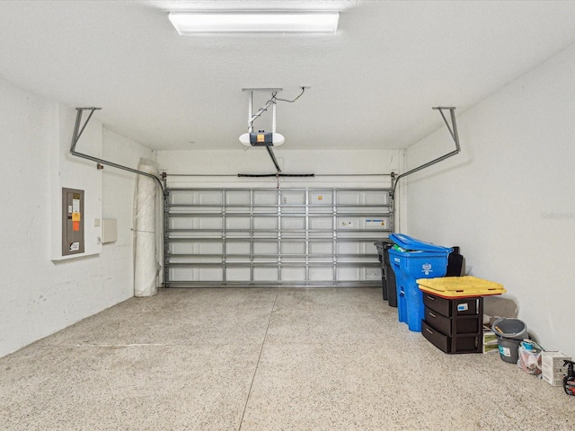 garage featuring electric panel and a garage door opener