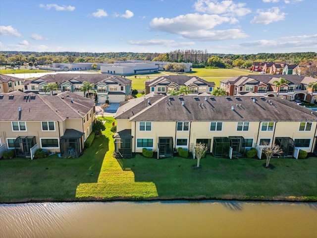 drone / aerial view with a residential view and a water view