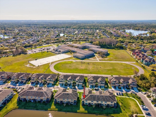 drone / aerial view with a residential view and a water view