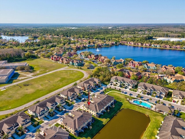 drone / aerial view with a water view and a residential view