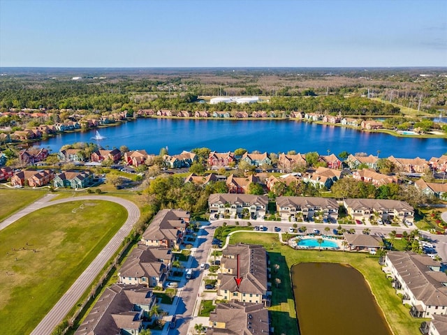 drone / aerial view featuring a water view and a residential view