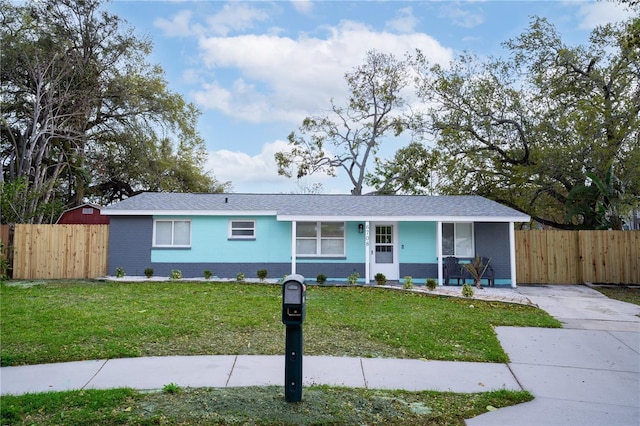 ranch-style house with brick siding, covered porch, a front lawn, and fence