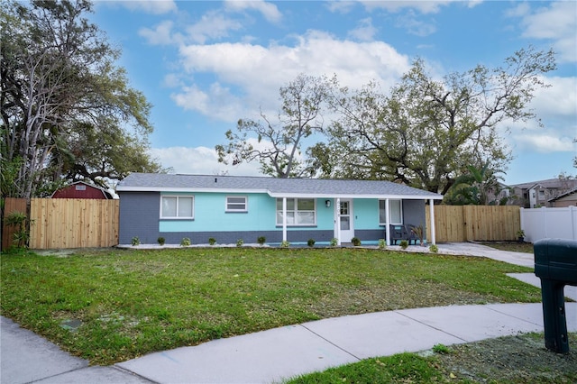 ranch-style home with a gate, fence, a porch, a front lawn, and brick siding