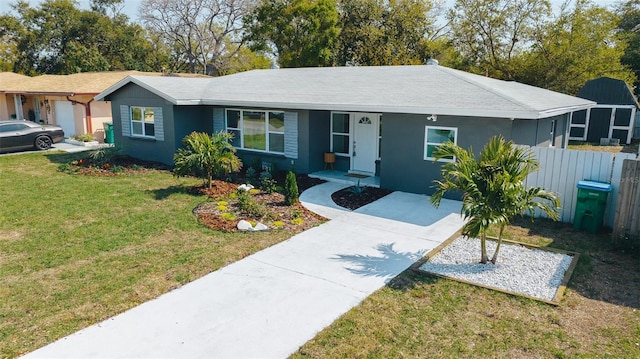 ranch-style house with stucco siding, concrete driveway, a front lawn, and fence