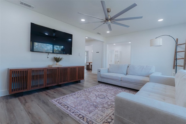 living room featuring recessed lighting, visible vents, baseboards, and wood finished floors