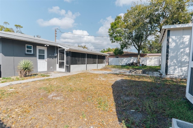 view of yard featuring a sunroom and fence