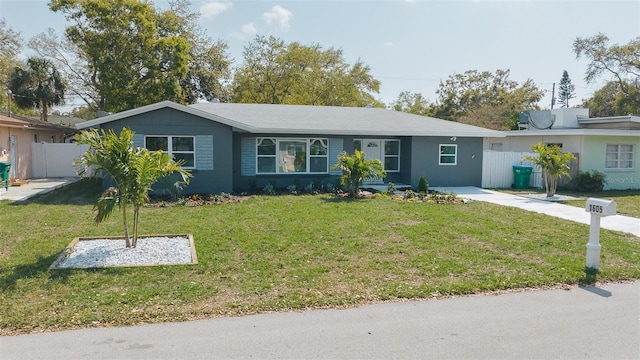 ranch-style house featuring a front yard and fence