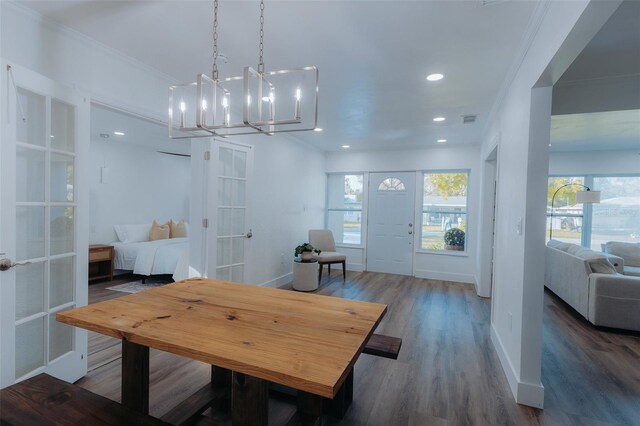 1605 Crown St, Clearwater, FL 33755 - dining room featuring french doors, visible vents, a notable chandelier, wood finished floors, and ornamental molding