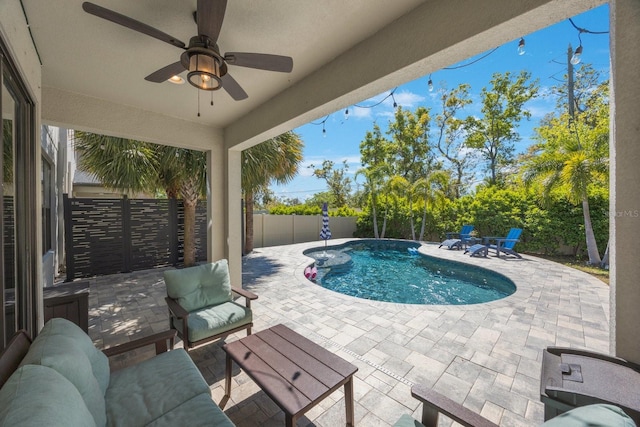 view of swimming pool with a patio area, a fenced in pool, a fenced backyard, and ceiling fan