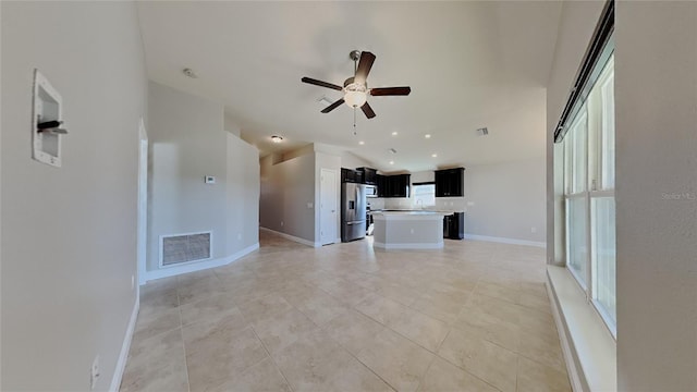 unfurnished living room featuring visible vents, baseboards, light tile patterned flooring, and a ceiling fan