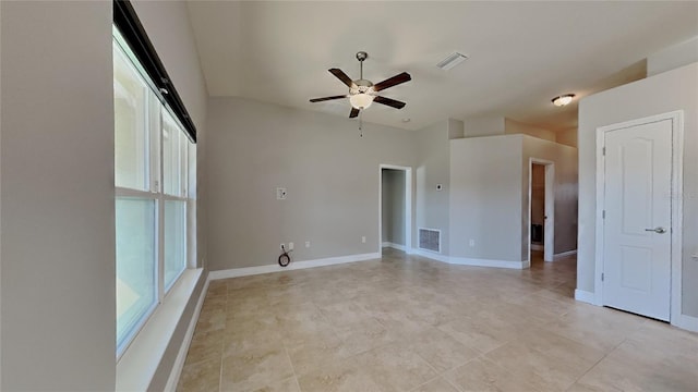 empty room with visible vents, baseboards, and a ceiling fan