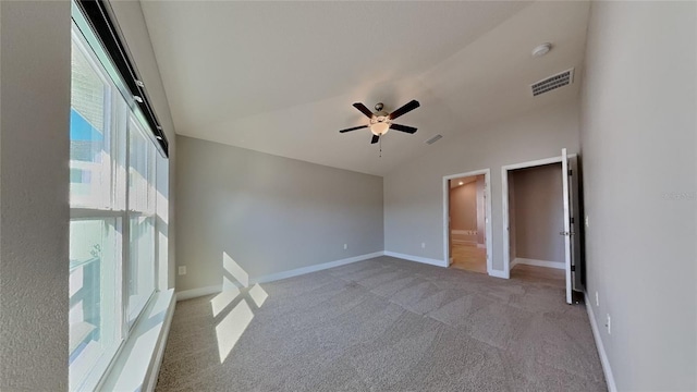 unfurnished bedroom featuring carpet, lofted ceiling, visible vents, and baseboards