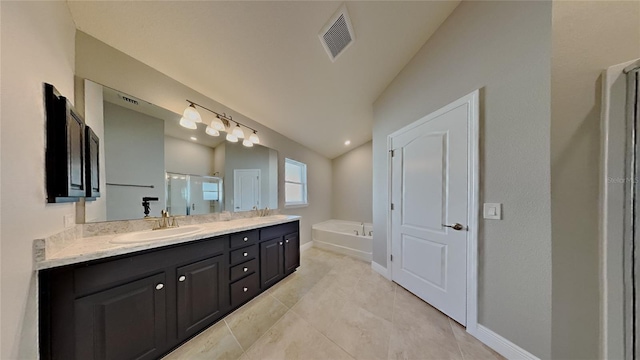 full bathroom featuring visible vents, double vanity, a stall shower, a sink, and a garden tub