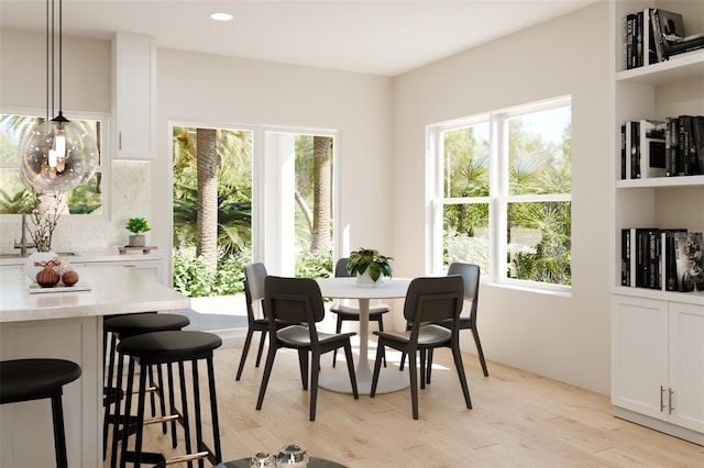 dining room with recessed lighting and light wood-style flooring