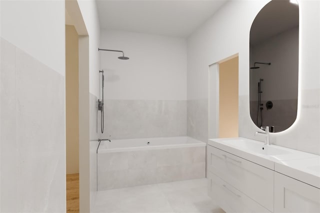 bathroom with tiled tub, walk in shower, and vanity